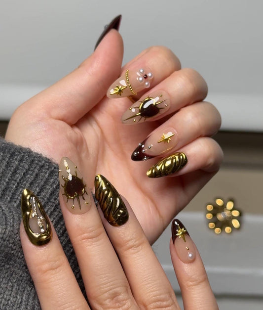 Regal Romance almond-shaped nail art  Set with rich burgundy and gold designs, featuring hearts, pearls, roses and stars