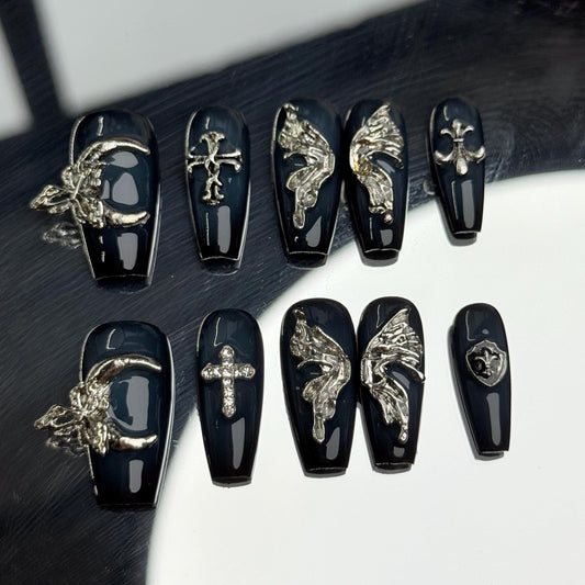 Gothic Wings Coffin Handmade nail art set with gothic black and silver designs, featuring winged motifs and crosses for an edgy look.