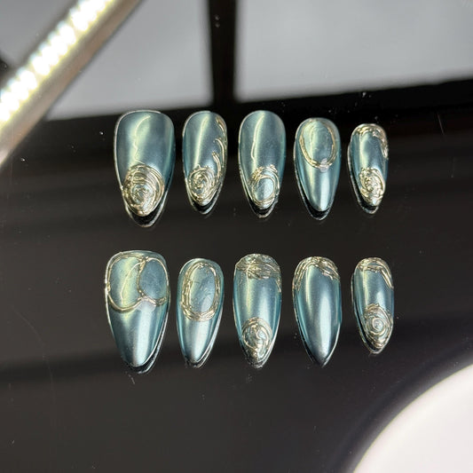 Mystic Teal Blue Chrome Almond Press-On Nails with Elegant Gold Swirl Accents for a Stunning, Reflective Finish