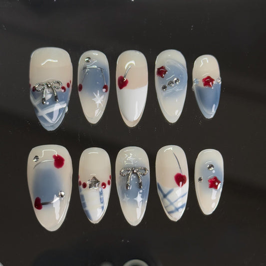 Cherry Bow Press-on Set With Ombre Soft Blue And Cherry Embellishement Creamy White Base with Romantic Bow and Silver Accents